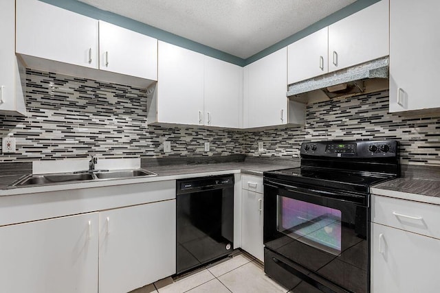 1530 Cypress Way Unit E, Palm Springs, FL 33406 - kitchen with black appliances, under cabinet range hood, white cabinets, light tile patterned flooring, and tasteful backsplash