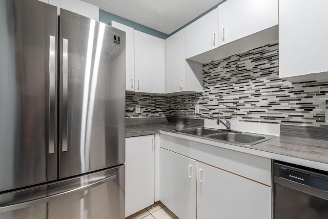 1530 Cypress Way Unit E, Palm Springs, FL 33406 - kitchen with appliances with stainless steel finishes, decorative backsplash, and white cabinetry