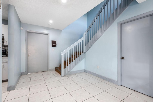 1530 Cypress Way Unit E, Palm Springs, FL 33406 - foyer featuring stairway, light tile patterned floors, and recessed lighting