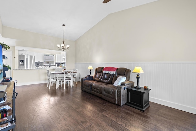 2950 SE Ocean Blvd Unit 119-6, Stuart, FL 34996 - living room featuring lofted ceiling, a chandelier, a wainscoted wall, dark wood-style floors, and ceiling fan