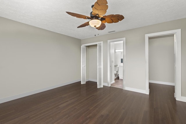 2950 SE Ocean Blvd Unit 119-6, Stuart, FL 34996 - unfurnished bedroom with wood finished floors, a textured ceiling, a ceiling fan, and ensuite bath