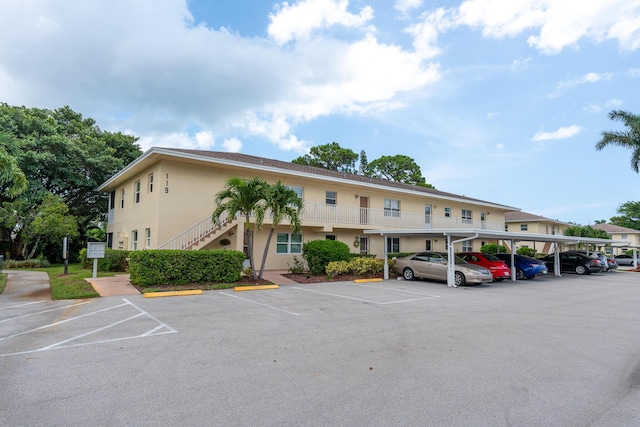 2950 SE Ocean Blvd Unit 119-6, Stuart, FL 34996 - view of property with covered and uncovered parking and stairway