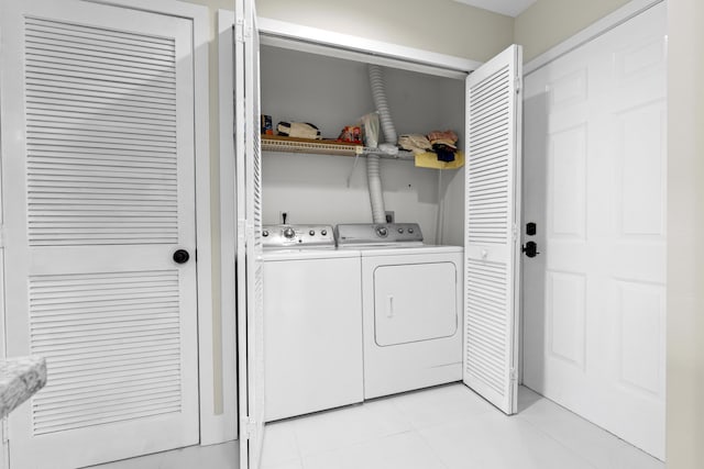 2950 SE Ocean Blvd Unit 119-6, Stuart, FL 34996 - laundry area with washer and dryer and light tile patterned floors