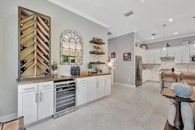572 SE Villandry Way, Port Saint Lucie, FL 34984 - indoor wet bar with beverage cooler, high end fridge, crown molding, tasteful backsplash, and hanging light fixtures