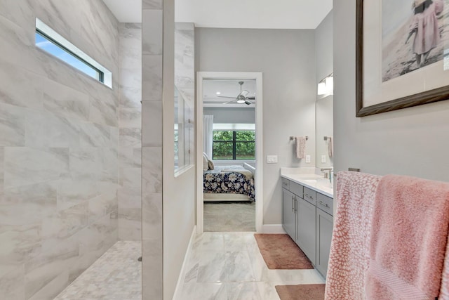 572 SE Villandry Way, Port Saint Lucie, FL 34984 - ensuite bathroom with marble look tile flooring, a walk in shower, vanity, and ceiling fan