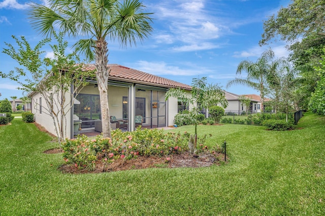 572 SE Villandry Way, Port Saint Lucie, FL 34984 - back of house with a sunroom, stucco siding, and a tiled roof