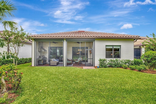 572 SE Villandry Way, Port Saint Lucie, FL 34984 - rear view of property featuring stucco siding, a tile roof, a lawn, and a sunroom