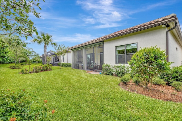 572 SE Villandry Way, Port Saint Lucie, FL 34984 - view of grassy yard featuring a sunroom