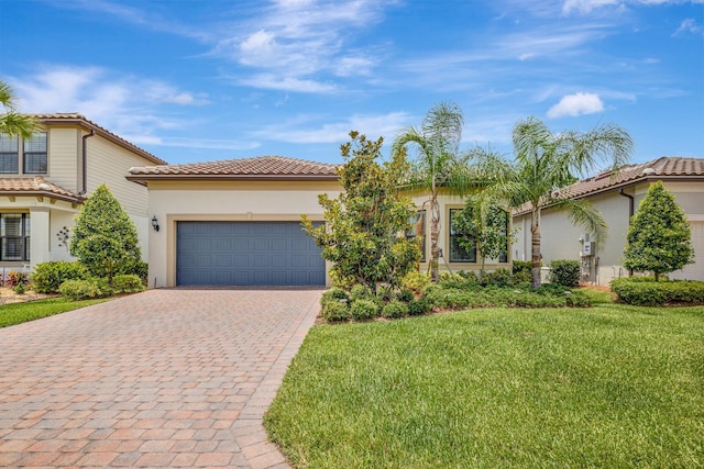 572 SE Villandry Way, Port Saint Lucie, FL 34984 - mediterranean / spanish house with decorative driveway, a garage, a tiled roof, a front yard, and stucco siding