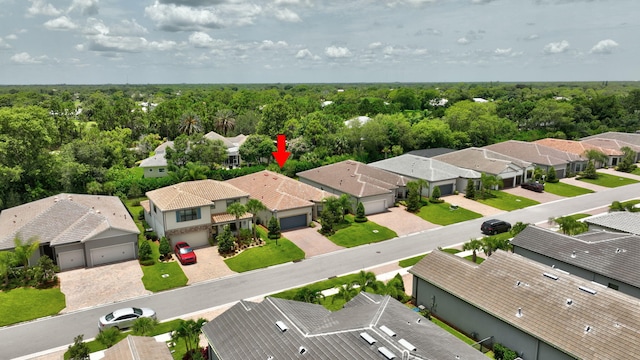572 SE Villandry Way, Port Saint Lucie, FL 34984 - aerial view of residential area featuring a heavily wooded area