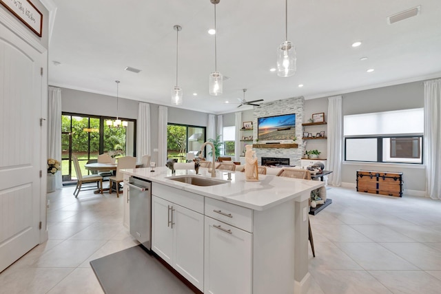 572 SE Villandry Way, Port Saint Lucie, FL 34984 - kitchen with a fireplace, light tile patterned floors, stainless steel dishwasher, a kitchen island with sink, and recessed lighting
