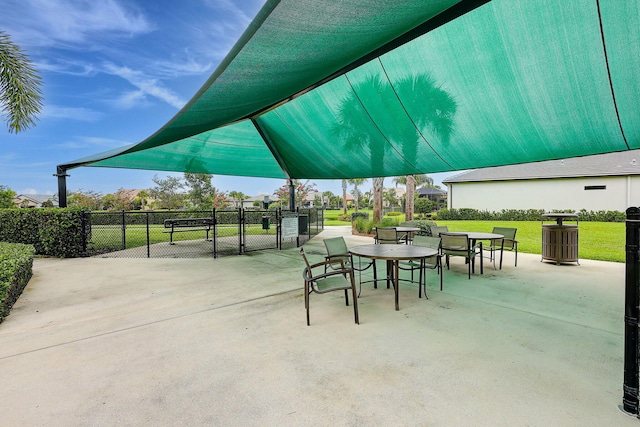 572 SE Villandry Way, Port Saint Lucie, FL 34984 - view of patio with a gate and outdoor dining area