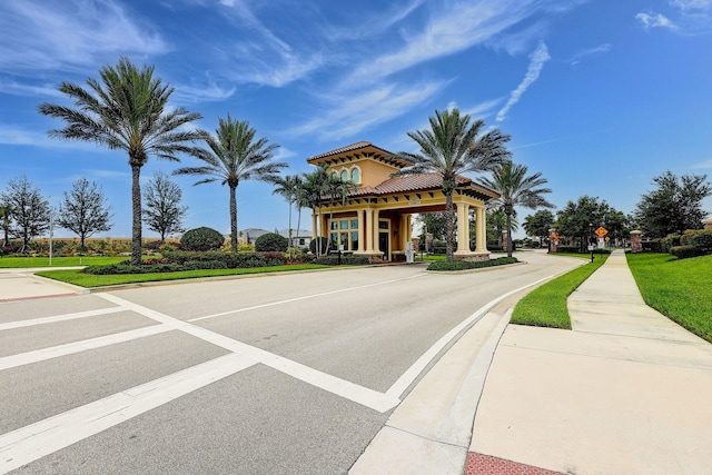 572 SE Villandry Way, Port Saint Lucie, FL 34984 - view of asphalt street featuring sidewalks, curbs, and traffic signs