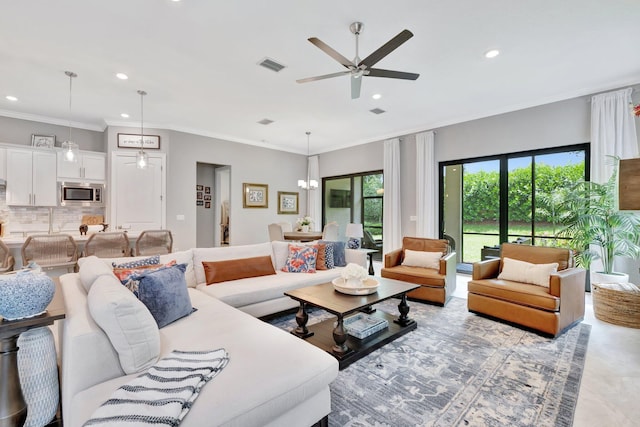 572 SE Villandry Way, Port Saint Lucie, FL 34984 - living room with recessed lighting, a ceiling fan, ornamental molding, and a chandelier