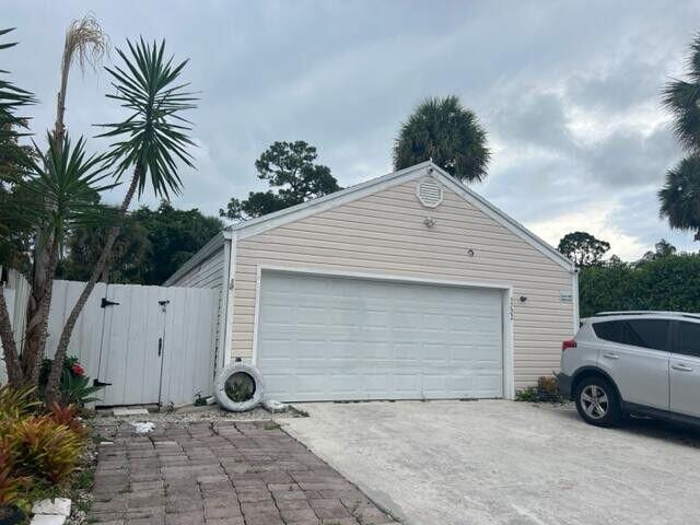 5722 Dewberry Way, West Palm Beach, FL 33415 - garage featuring a gate