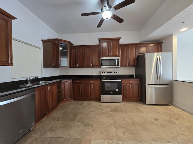 1620 Presidential Way Unit 106, West Palm Beach, FL 33401 - kitchen featuring stainless steel appliances, dark countertops, ceiling fan, glass insert cabinets, and dark brown cabinets