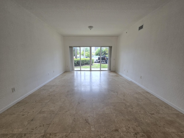 1620 Presidential Way Unit 106, West Palm Beach, FL 33401 - unfurnished room featuring baseboards and a textured wall
