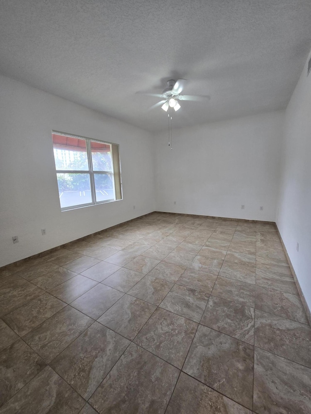 1620 Presidential Way Unit 106, West Palm Beach, FL 33401 - empty room featuring a ceiling fan and a textured ceiling