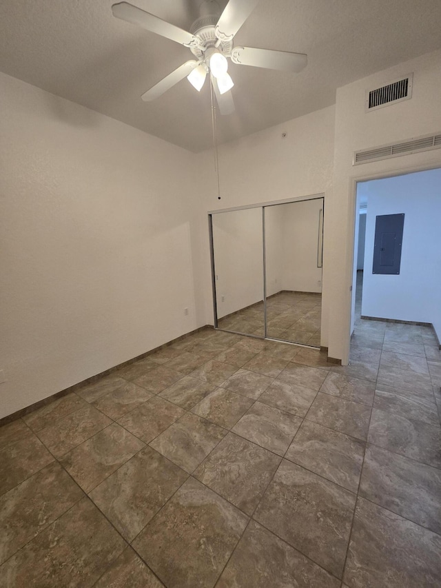 1620 Presidential Way Unit 106, West Palm Beach, FL 33401 - unfurnished bedroom featuring electric panel, a closet, and ceiling fan