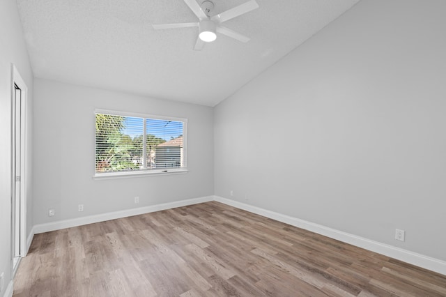 6976 Thicket Trce, Lake Worth, FL 33467 - empty room with vaulted ceiling, wood finished floors, and a ceiling fan