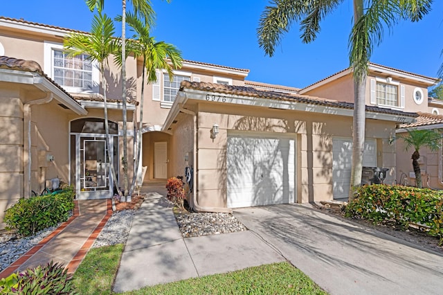6976 Thicket Trce, Lake Worth, FL 33467 - view of property with stucco siding, concrete driveway, and a tiled roof