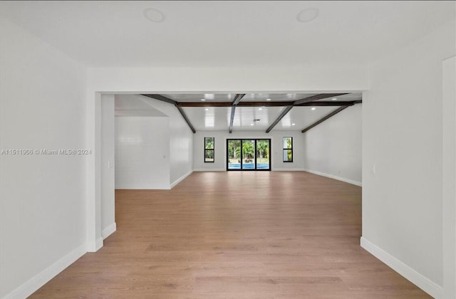 15763 Alexander Run, Jupiter, FL 33478 - unfurnished living room with light wood-style floors, beamed ceiling, and recessed lighting