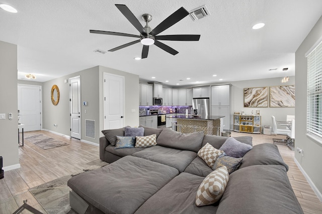16360 Oakview Dr, Westlake, FL 33470 - living room with ceiling fan, light wood finished floors, a textured ceiling, and recessed lighting