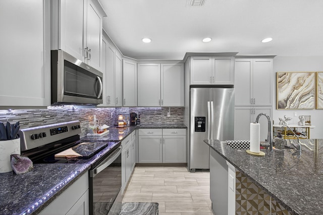 16360 Oakview Dr, Westlake, FL 33470 - kitchen with stainless steel appliances, dark stone countertops, tasteful backsplash, and recessed lighting