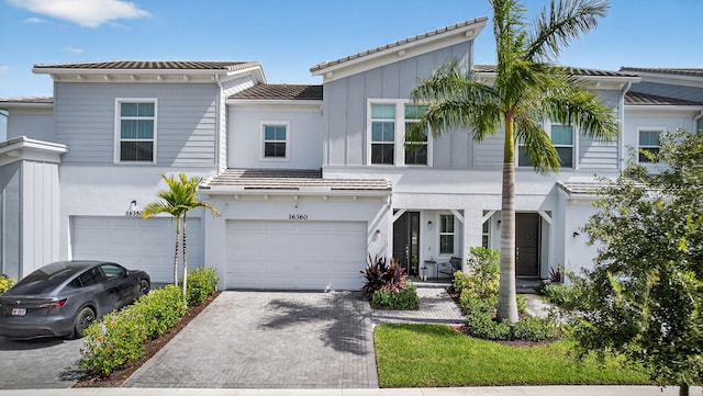 16360 Oakview Dr, Westlake, FL 33470 - view of front facade featuring an attached garage, decorative driveway, a tile roof, and stucco siding