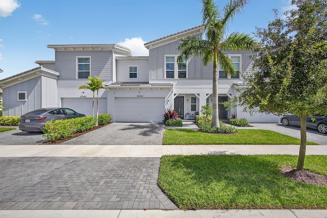 16360 Oakview Dr, Westlake, FL 33470 - view of property with decorative driveway, an attached garage, stucco siding, and a front lawn