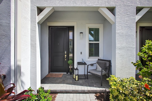 16360 Oakview Dr, Westlake, FL 33470 - view of exterior entry with stucco siding and a porch