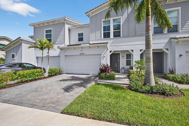 16360 Oakview Dr, Westlake, FL 33470 - townhome / multi-family property featuring decorative driveway, an attached garage, and stucco siding