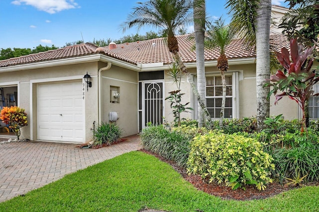 9484 Swansea Ln, West Palm Beach, FL 33411 - view of front facade featuring an attached garage, stucco siding, and a tiled roof