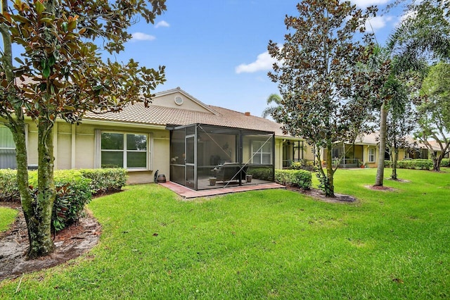 9484 Swansea Ln, West Palm Beach, FL 33411 - rear view of property featuring stucco siding, a yard, glass enclosure, and a tiled roof