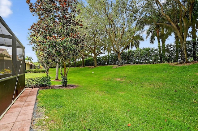 9484 Swansea Ln, West Palm Beach, FL 33411 - view of green lawn with a lanai