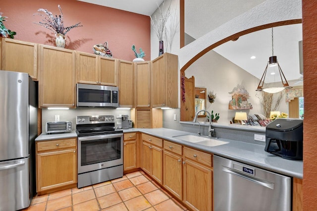 9484 Swansea Ln, West Palm Beach, FL 33411 - kitchen with appliances with stainless steel finishes, light tile patterned floors, light countertops, arched walkways, and recessed lighting
