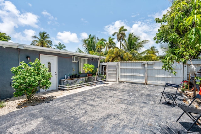 4740 NE 17th Ave, Pompano Beach, FL 33064 - view of patio featuring a wall mounted AC