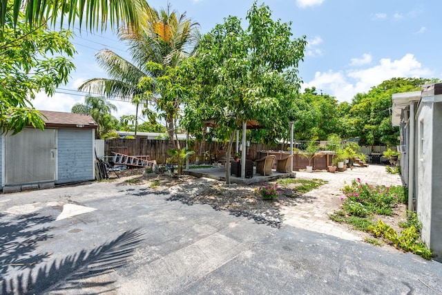 4740 NE 17th Ave, Pompano Beach, FL 33064 - fenced backyard with a patio and a storage shed