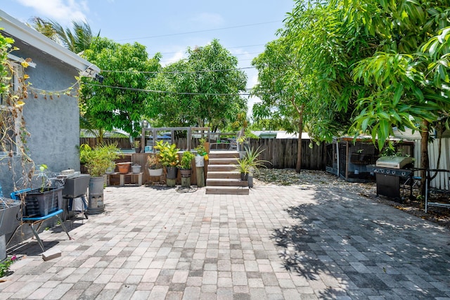 4740 NE 17th Ave, Pompano Beach, FL 33064 - fenced backyard with area for grilling, a patio, and a wooden deck