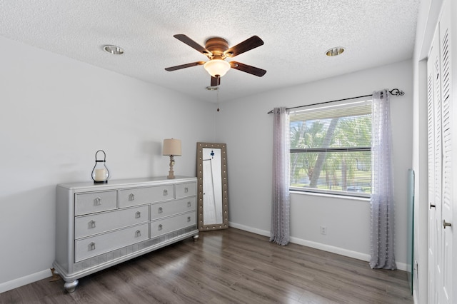 22100 Palms Way Unit 204, Boca Raton, FL 33433 - bedroom featuring wood finished floors, a textured ceiling, and a ceiling fan