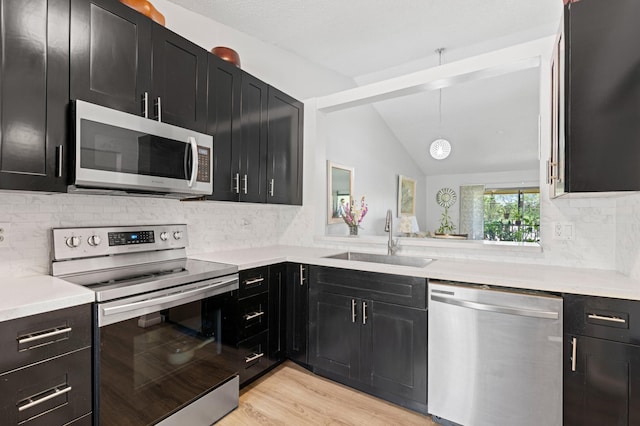 22100 Palms Way Unit 204, Boca Raton, FL 33433 - kitchen with appliances with stainless steel finishes, dark cabinetry, lofted ceiling, light countertops, and tasteful backsplash
