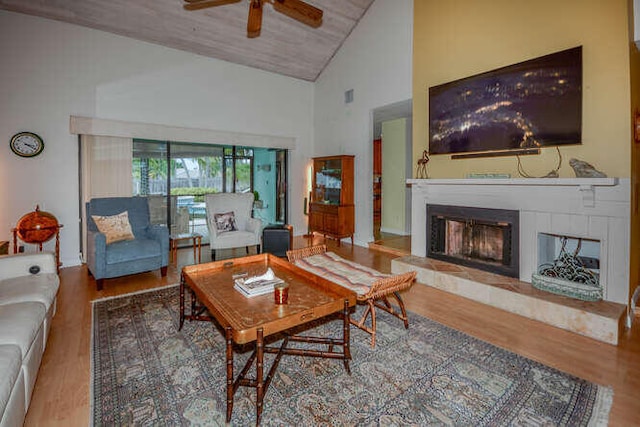 45 Birch Pl, Tequesta, FL 33469 - living room with high vaulted ceiling, a fireplace with raised hearth, wood finished floors, ceiling fan, and wood ceiling