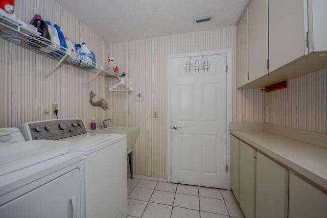 45 Birch Pl, Tequesta, FL 33469 - washroom featuring cabinet space, light tile patterned floors, and washing machine and clothes dryer