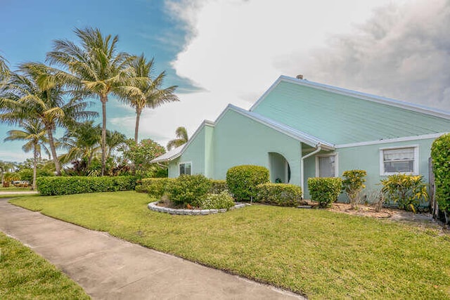 45 Birch Pl, Tequesta, FL 33469 - view of property exterior with stucco siding and a yard