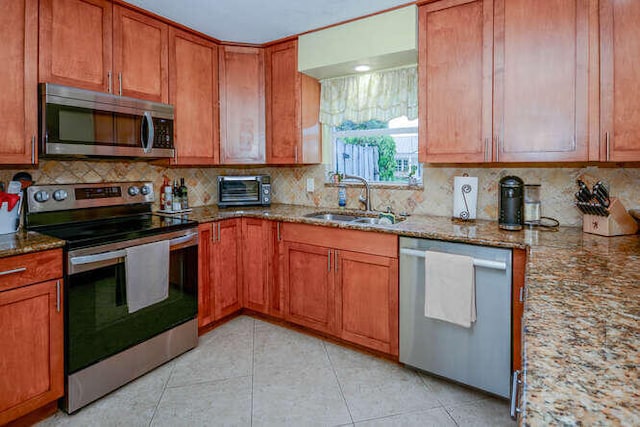 45 Birch Pl, Tequesta, FL 33469 - kitchen featuring appliances with stainless steel finishes, stone counters, and backsplash