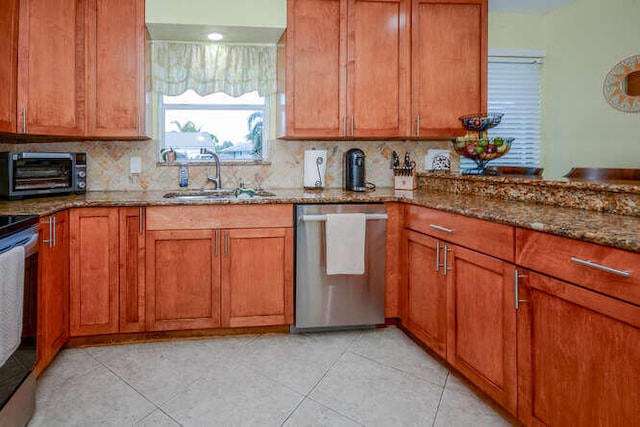 45 Birch Pl, Tequesta, FL 33469 - kitchen featuring appliances with stainless steel finishes, dark stone countertops, tasteful backsplash, and brown cabinets