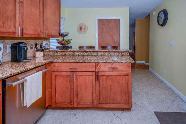 45 Birch Pl, Tequesta, FL 33469 - kitchen featuring dishwasher, a peninsula, light tile patterned flooring, light stone countertops, and decorative backsplash