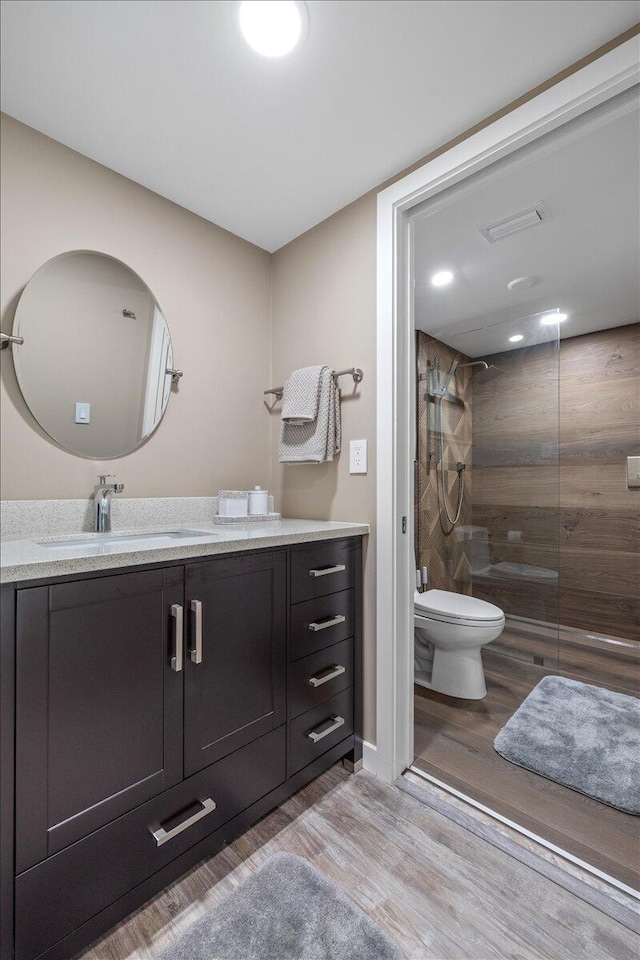 11863 Wimbledon Cir Unit 438, Wellington, FL 33414 - bathroom with tiled shower, wood finished floors, and vanity