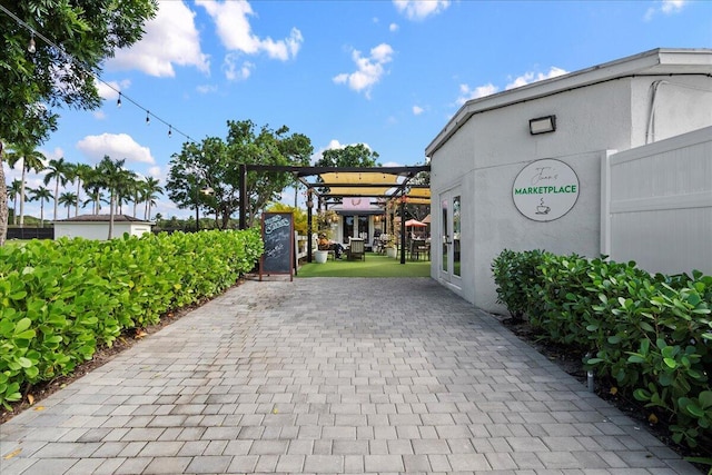 11863 Wimbledon Cir Unit 438, Wellington, FL 33414 - view of community featuring a pergola and a patio area