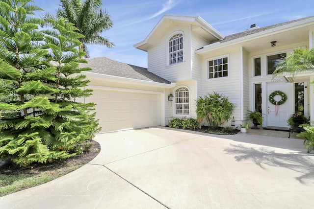 2000 SW Oakwater Pt, Palm City, FL 34990 - view of front facade with a garage, driveway, and roof with shingles